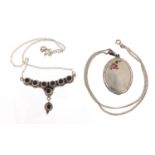 Oval silver locket enamelled with a rose and a silver necklace set with cabochon amethyst stones,