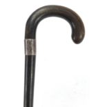 Ebonised walking stick with rhinoceros horn handle and silver collar, 85cm in length