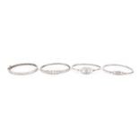 Four silver bangles including Greek key design and one set with clear stones, 49.6g