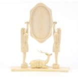 African ivory swing mirror carved with carved figural supports in the form of semi nude females,