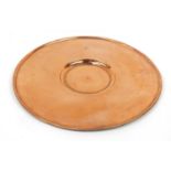 Antique copper alms dish with engraved crest and impressed cross, 45.5cm in diameter