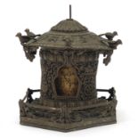 Tibetan silver coloured metal rotating shrine embossed with script, fish and flowers, 18cm high