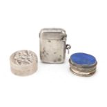 Two silver pill boxes and a vesta including one embossed with a hunting dog and one with lapis
