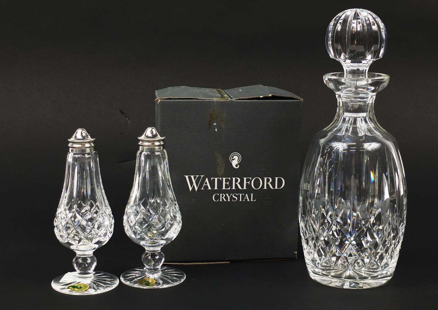 Waterford Crystal comprising a Lismore pattern decanter and salt and pepper sifters with box, the
