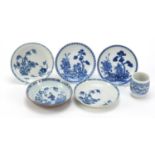 Five Chinese blue and white porcelain dishes and a barrel, each hand painted with a river landscape,