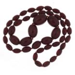 Cherry amber coloured bead necklace, 80cm in length, the largest bead 2.9cm in length, 81.0g