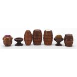 19th century sewing interest carved coquilla nuts comprising three pin cushions and four barrel