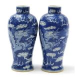 Pair of Chinese blue and white porcelain baluster vases hand painted with dragons amongst clouds,
