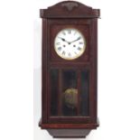 Oak wall clock with bevelled panels and enamel dial having Roman numerals, 78cm high