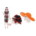 Three Art Deco design brooches comprising a female with a handbag, female wearing a hat and an
