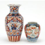 Two Japanese Imari porcelain vases hand painted with flowers, the largest 22cm high