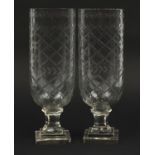 Pair of Georgian design cut glass celery vases raised on stepped square bases, each 34cm high