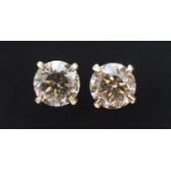 Pair of 18ct white gold diamond solitaire stud earrings, approximately 4.50 carat in total,