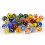 Thirty two marbles including German Lattino examples, all with pontil marks, the largest 2.4cm in