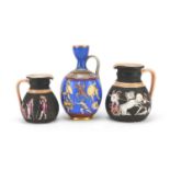 Three Greek design jugs including a facsimile of a vase representing the battle between the Greeks