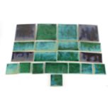 Carter & Co, twenty early Poole Pottery square and rectangular tiles having purple and green glazes,