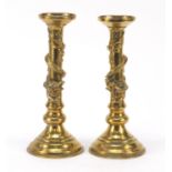 Pair of Chinese bronze dragon design candlesticks, each 24cm high