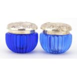 Two blue glass jars with sterling silver lids embossed with flowers, each 4.5cm high