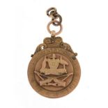 9ct gold rifle jewel, relief decorated with an Australian coat of arms, engraved His country called,