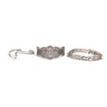 Three silver bracelets including a filigree example and one decorated with Egyptian hieroglyphics,