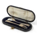 Continental silver christening fork and spoon housed in velvet and silk lined leather case, the