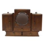 Art Deco oak wall hanging unit with bevelled peach glass mirror, having three cupboard doors above