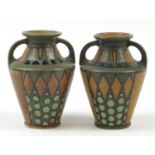 Quimper, Near pair of French Art Deco pottery Odetta vases with twin handles, hand painted with