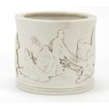 Chinese white monochrome porcelain brush pot decorated in relief with monks, scholars and bamboo