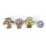 Four vintage car badges including Rotary International