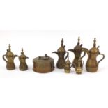 Middle Eastern metalware including seven Omani coffee pots, the largest 30cm high