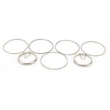 Two silver hinged christening bracelets and five silver coloured metal bangles, 30.5g