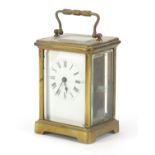 Brass cased carriage clock with enamel dial having Roman numerals, 11cm high