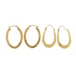 Two pairs of 9ct gold hoop earrings, the largest 2.6cm high, total 2.1g