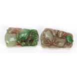 Two Chinese green jade pendants carved with fruit and dragons, each 6cm high