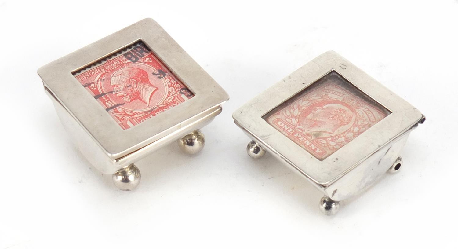 Two Victorian and later silver stamp boxes with hinged lids, each raised on four ball feet,