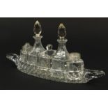 Cut glass boat cruet stand with bottles, 31cm wide