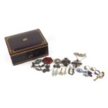 Silver and white metal jewellery housed in a Victorian tooled leather box, including brooches, rings