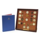 The Queen's Guards Collection by the Birmingham Mint with a framed display of silver coins and cap