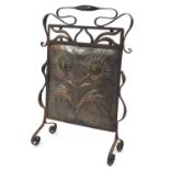 Art and Crafts wrought iron and copper firecreen, the hand beaten flowers inset with ceramic panels,