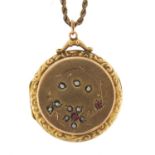 Gold plated locket set with pink stones and seed pearls on a gold coloured metal rope twist