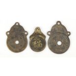 Three Chinese cash coin design bronze pendants, the largest 6.5cm high