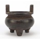 Chinese patinated bronze tripod censer with twin handles, impressed character marks to the base,