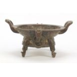 Chinese patinated bronze four footed archaic style dish with twin handles engraved with calligraphy,