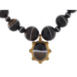 Scottish agate bead necklace with unmarked gold pendant, (tests as 14ct gold) 58cm in length, the