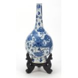 Large Chinese blue and white porcelain vase on a carved hardwood stand, hand painted with a dragon