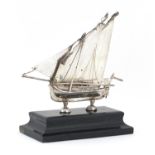 Maltese silver model of a sailing vessel raised on an ebonised stand, overall 12.5cm high