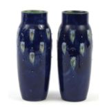 Royal Doulton, Pair of Art Nouveau stoneware vases hand painted with stylised flowers, numbered