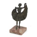 Patinated bronze figure of a scantily dressed female dancer, raised on a square marble base in the