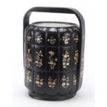 Chinese black lacquered three section food carrier with mother of pearl foliate inlay, 38cm high