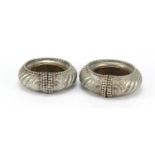 Two African silver coloured metal slave anklets, the largest 13cm in diameter